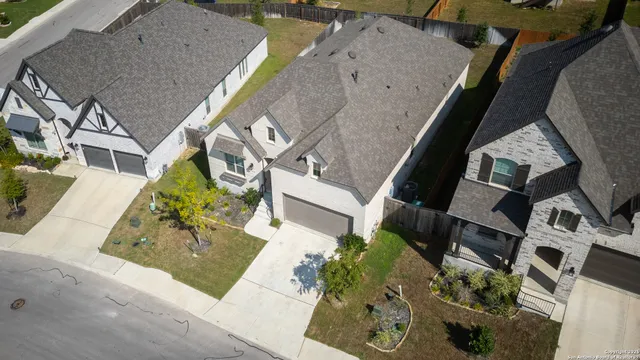 an aerial view of a house with a yard
