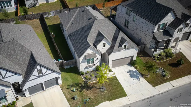 an aerial view of a house with a yard