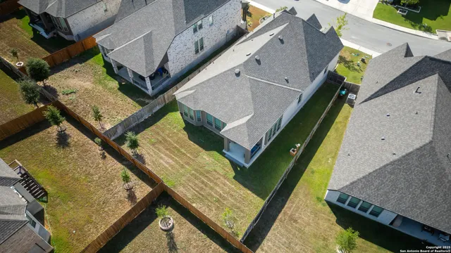 an aerial view of a house with a swimming pool