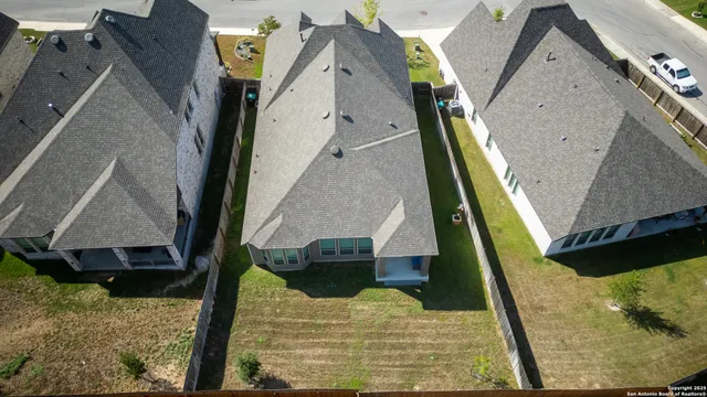 an aerial view of residential houses with outdoor space