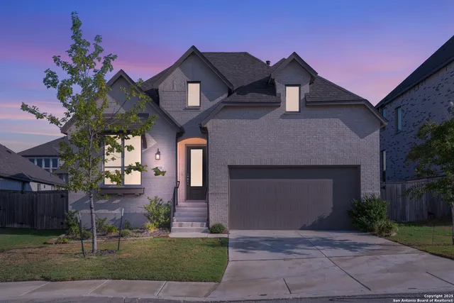 a front view of a house with a yard and garage