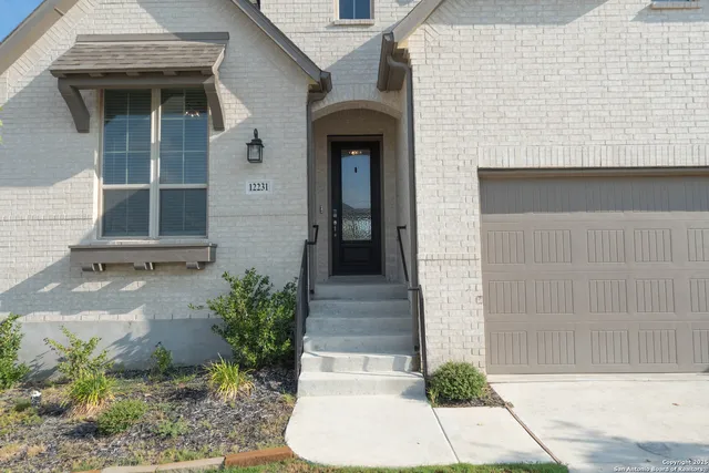 a front view of a house with a garden
