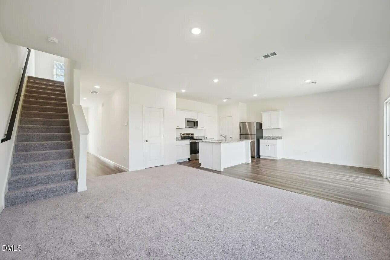 1325 Solace Way Rolesville, NC 27571 - Photo 12 of 29 a view of kitchen and hall with wooden floor