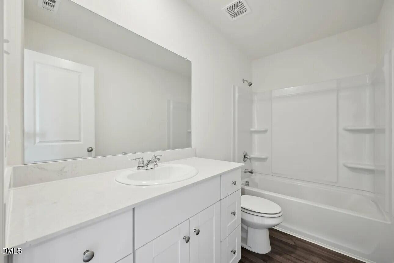 1325 Solace Way Rolesville, NC 27571 - Photo 19 of 29 a bathroom with a sink a toilet and shower
