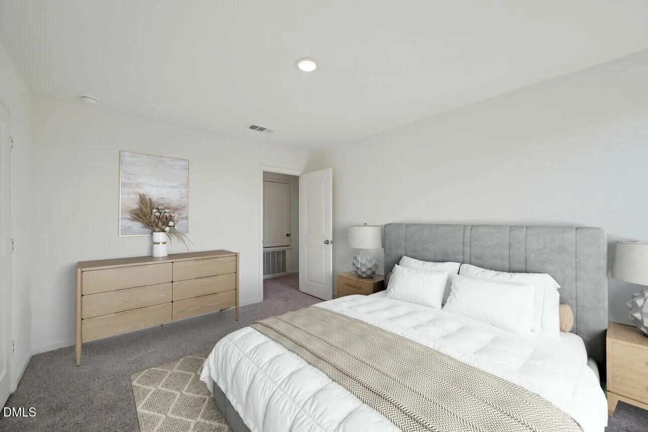 1325 Solace Way Rolesville, NC 27571 - Photo 6 of 29 a bedroom with a bed and a couch