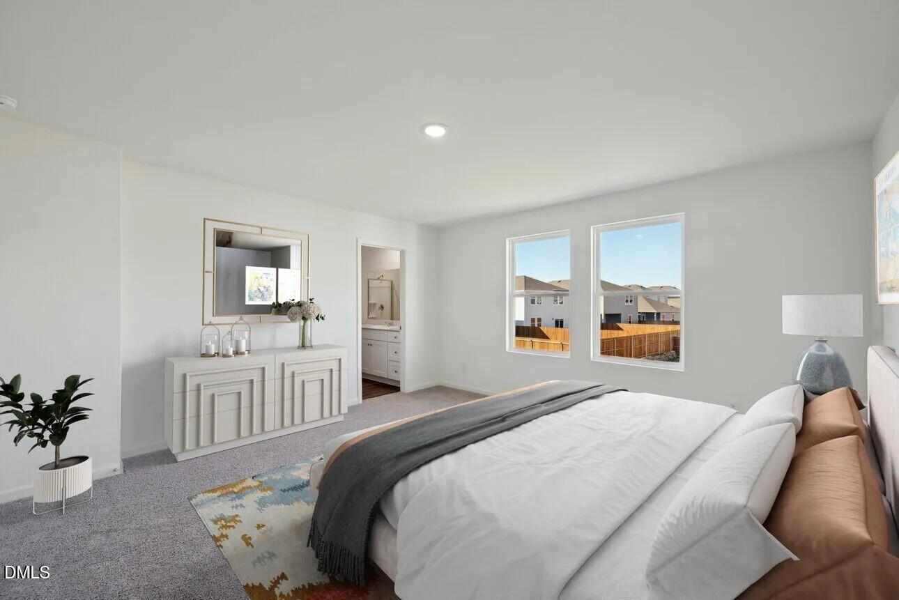 1325 Solace Way Rolesville, NC 27571 - Photo 8 of 29 a bedroom with a white bed and white cabinets