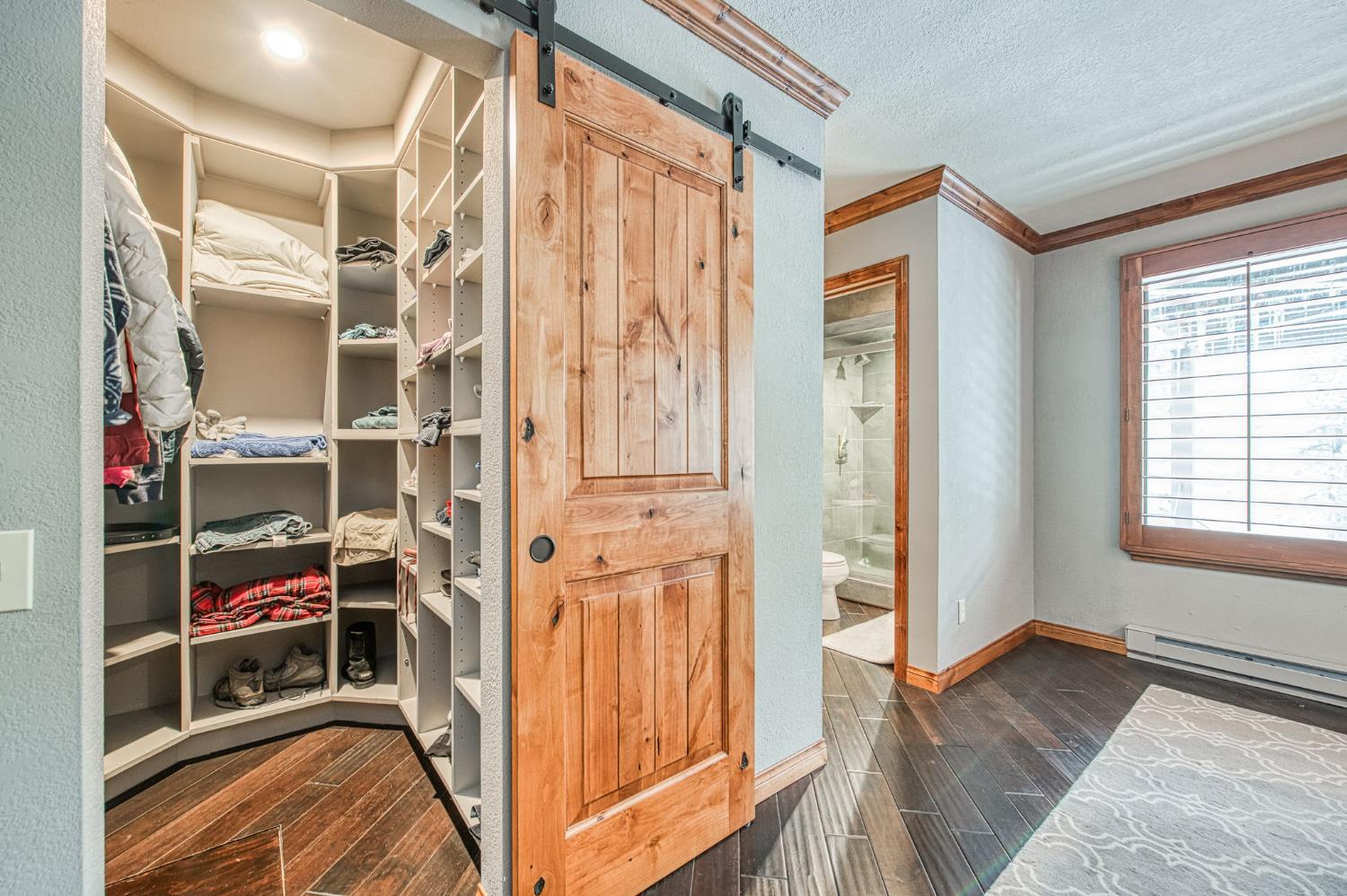 62687 Huntington Vista Road, Unit 114 Mono Hot Springs, CA 93642 - Photo 21 of 23 a view of a bedroom with wooden floor and windows