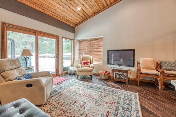 a bedroom with furniture and a large window