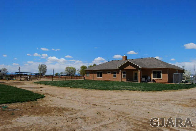 2003 Roma Avenue Fruita, CO 81521 - Photo 8 of 23 a front view of a house with a yard