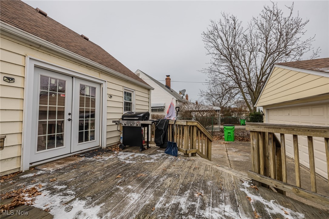 765 Pendley Road Willowick, OH 44095 - Photo 13 of 50 Snow covered deck featuring french doors and area for grilling