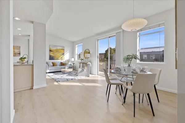 a view of a dining room with furniture and a large window