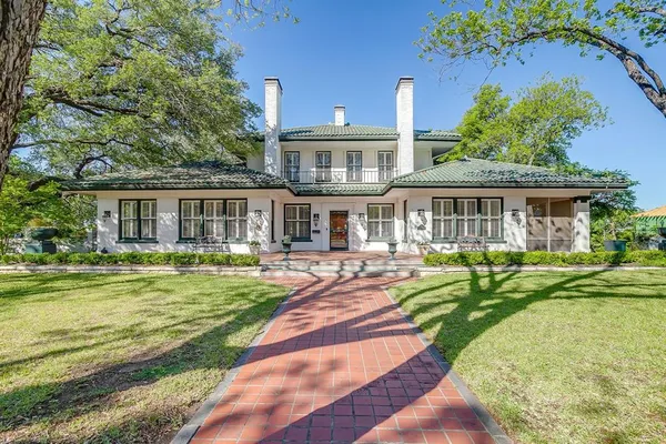 a front view of a house with swimming pool having outdoor seating