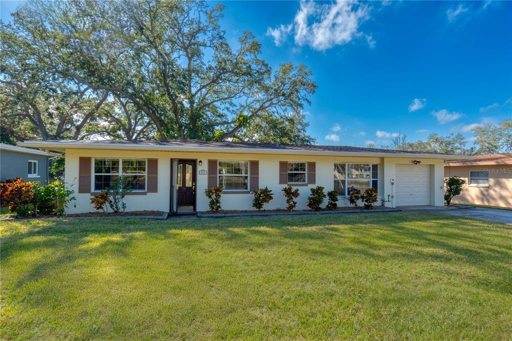 905 Palm Boulevard Dunedin, FL 34698 - Photo 1 of 1 a view of a house with a patio and a yard