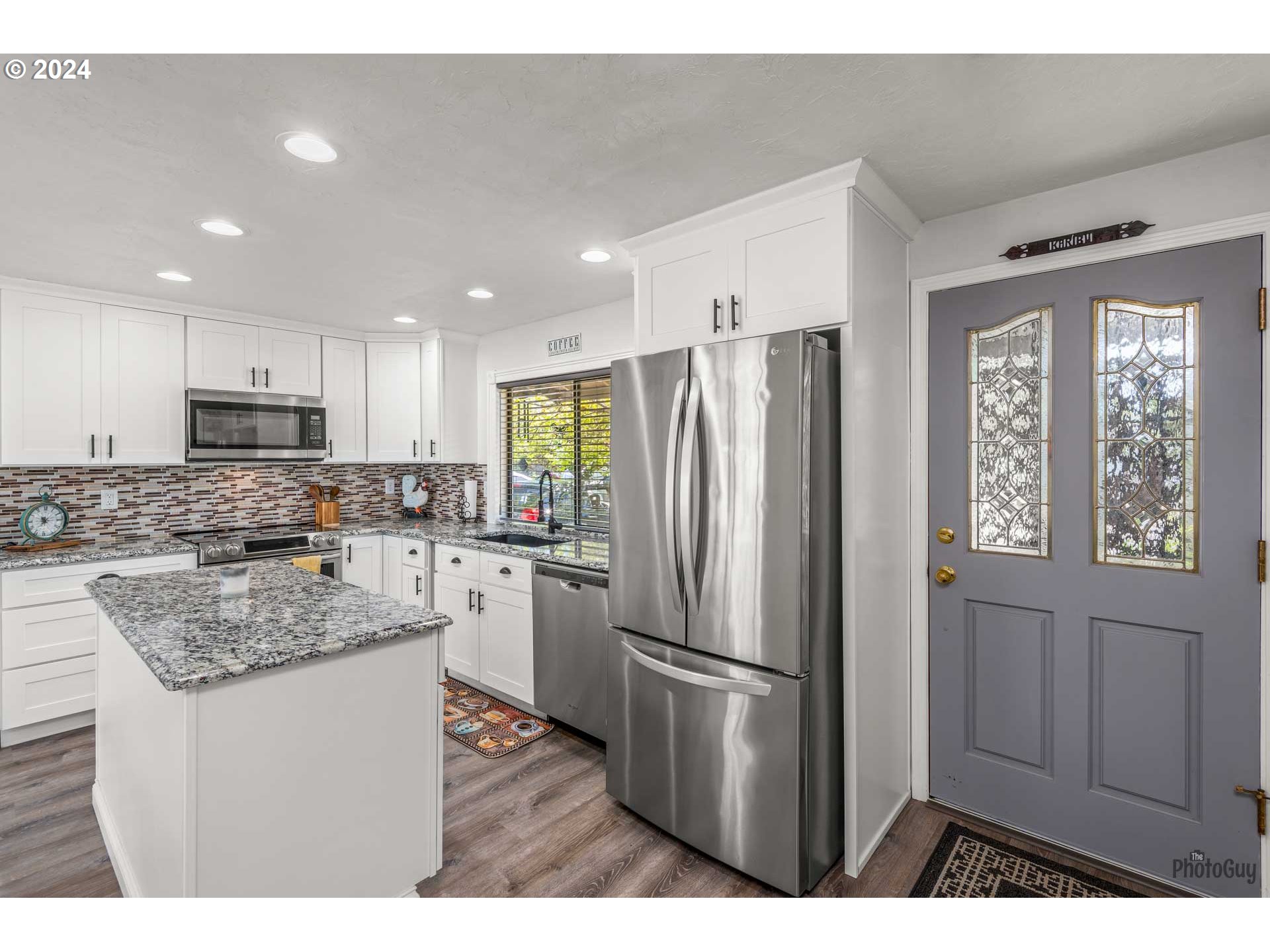 666 56th Street Springfield, OR 97478 - Photo 11 of 31 a kitchen with a refrigerator a sink and cabinets
