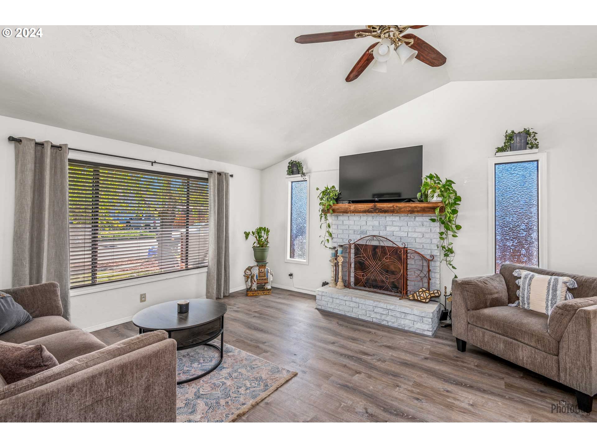 666 56th Street Springfield, OR 97478 - Photo 5 of 31 a living room with furniture a flat screen tv and a fireplace