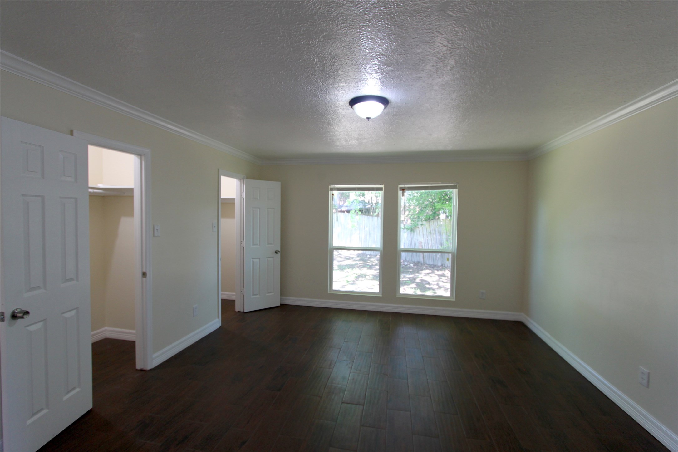 4330 Regency Villa Drive Houston, TX 77084 - Photo 7 of 13 an empty room with wooden floor and windows