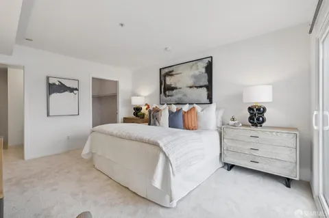 a bed room with a bed and a night stand