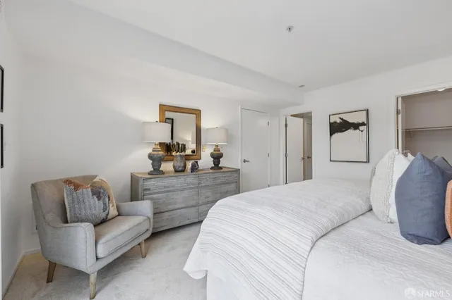 a bedroom with a bed and a couch