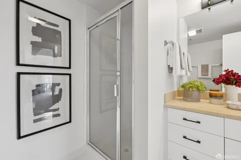 a view of a hallway with wooden floor and cabinet
