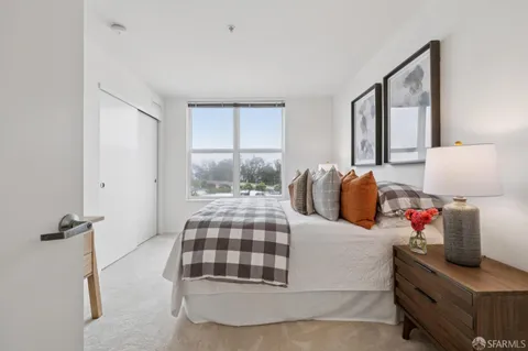 a bedroom with furniture and a window