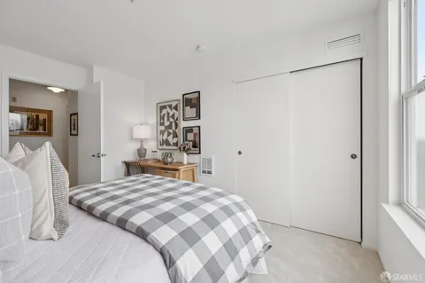 a bedroom with a bed and a cabinets