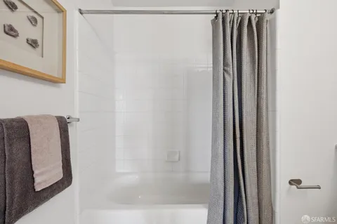 a bathroom with a shower and a tub