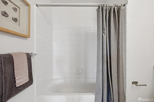 a bathroom with a shower and a tub