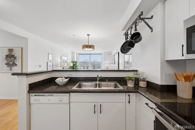 a kitchen with a sink a stove and cabinets