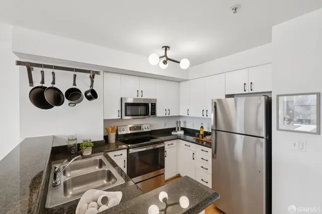 a kitchen with stainless steel appliances a refrigerator stove and microwave