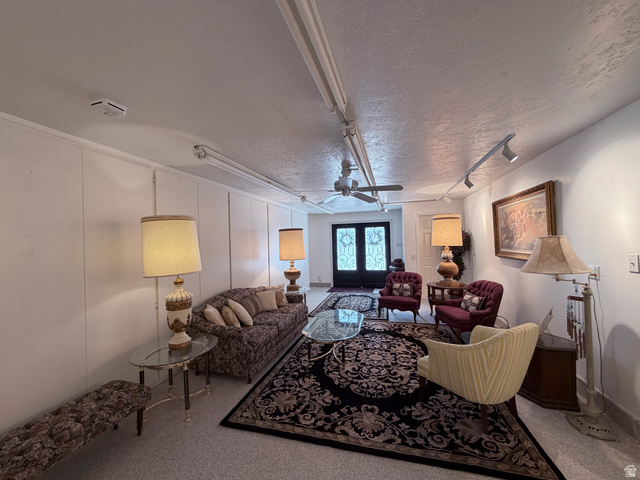 2855 South 1000 West Perry, UT 84302 - Photo 131 of 142 Carpeted living area with a textured ceiling, a decorative wall, ceiling fan, track lighting, and french doors