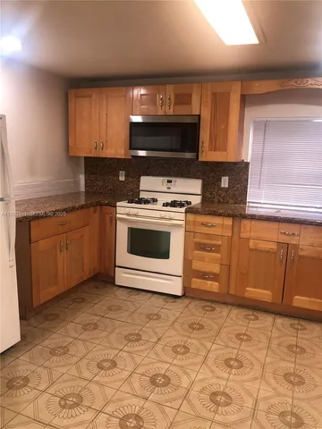 a kitchen with a sink and a stove top oven