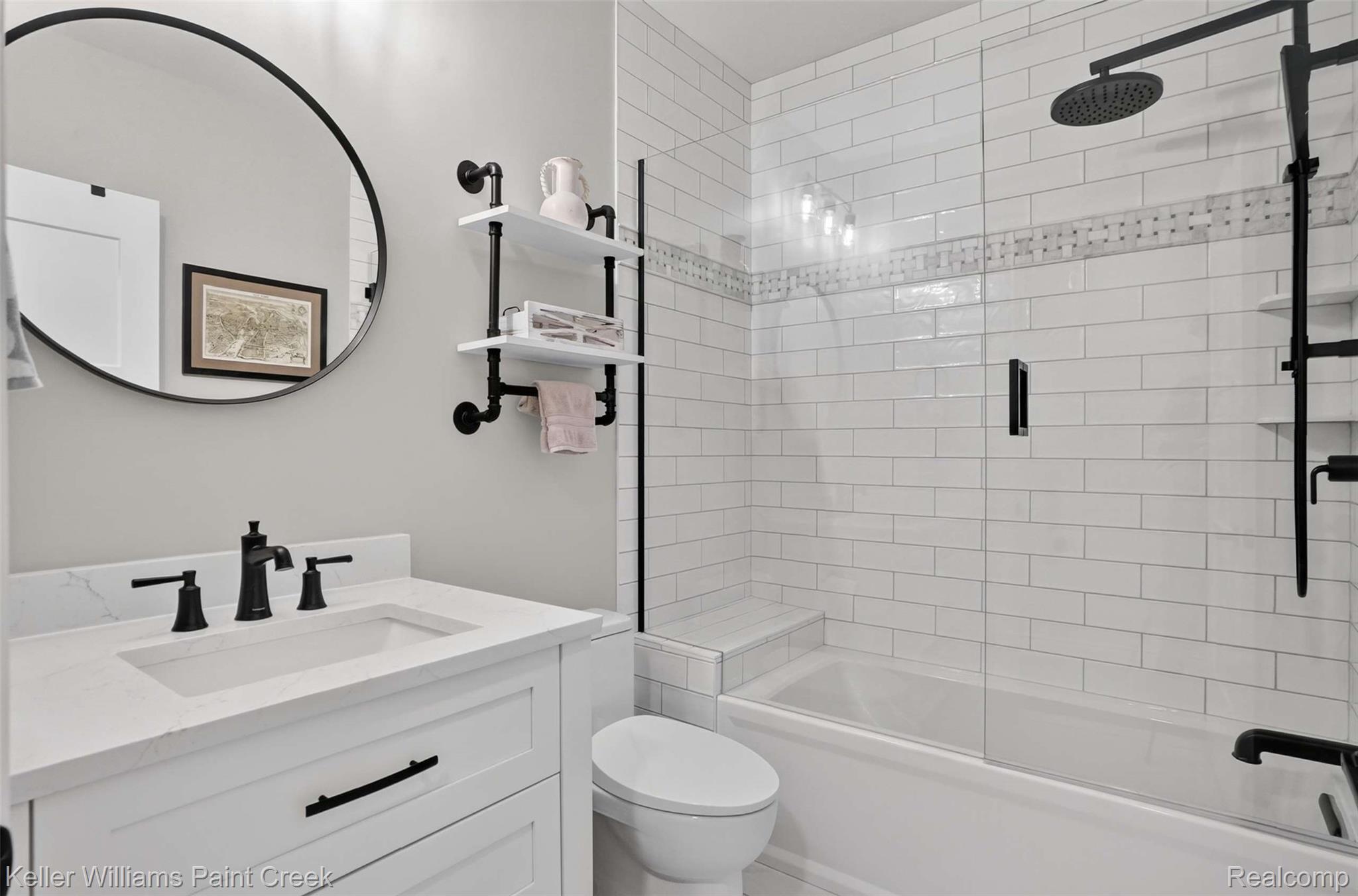 1221 North Main Street Rochester, MI 48307 - Photo 24 of 37 The Guest Bath has Wood Mode cabinetry, natural stone floor, Hansgrohe fixtures, Brizo oversized shower head, upgraded tub and Kohler seamless toilet