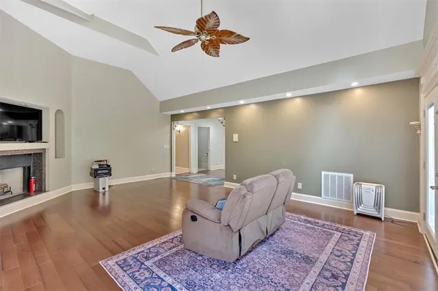 a kitchen with stainless steel appliances granite countertop a sink and a large window