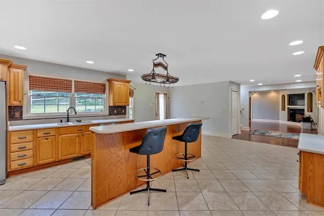a kitchen with stainless steel appliances granite countertop a refrigerator and a sink