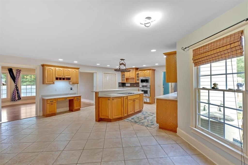 2 Stonebrook Drive Rome, GA 30165 - Photo 16 of 44 a large kitchen with stainless steel appliances a large counter top and a stove