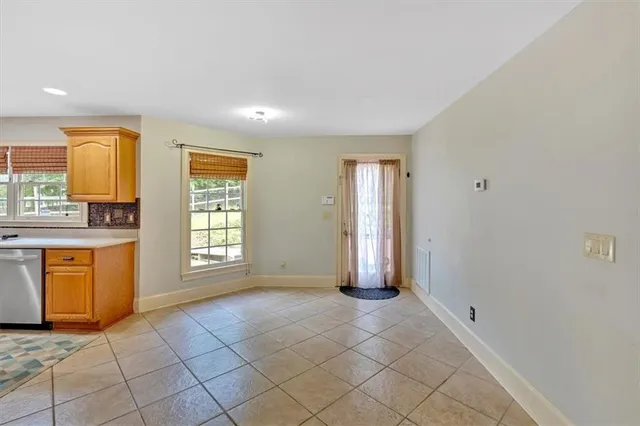 a view of a livingroom with wooden floor and a large window