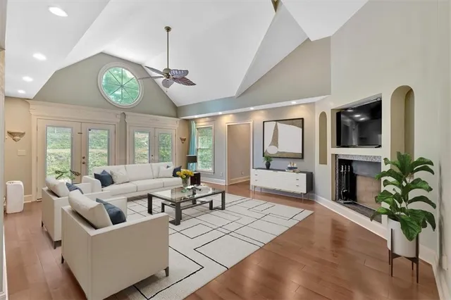a living room with stainless steel appliances kitchen island granite countertop furniture and a kitchen view