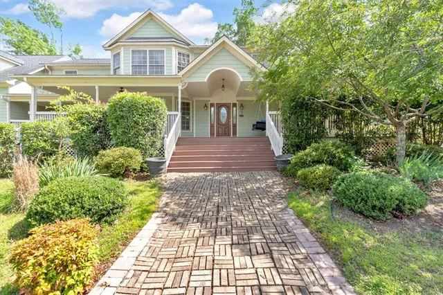 a view of a house with wooden floor and a porch