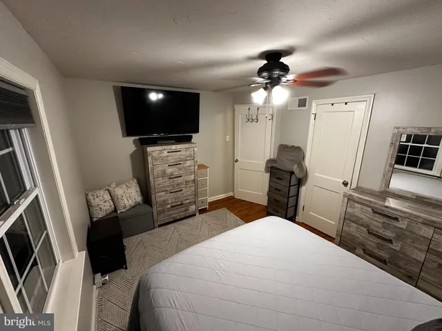 a living room with furniture window and a flat screen tv