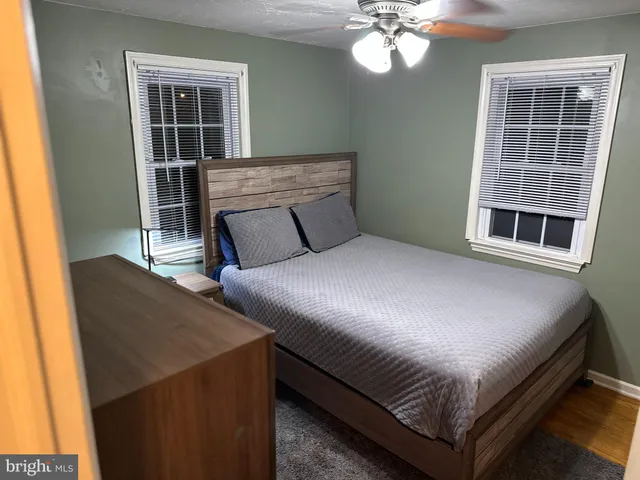 a bedroom with a bed lamps and chandelier