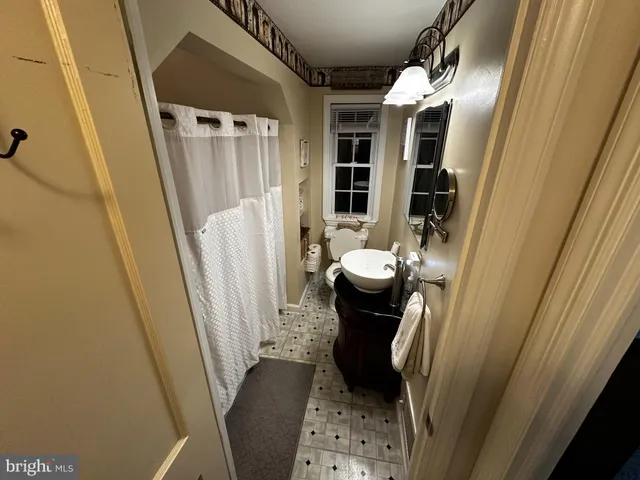 a bedroom with a bed window and a flat screen tv