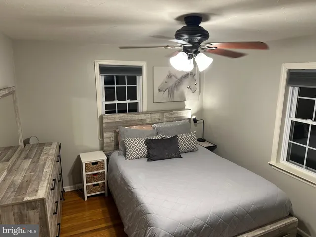 a view of a hallway with wooden floor and stairs