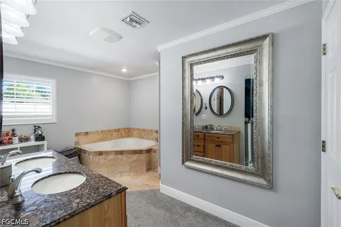 a bathroom with a granite countertop toilet sink and mirror