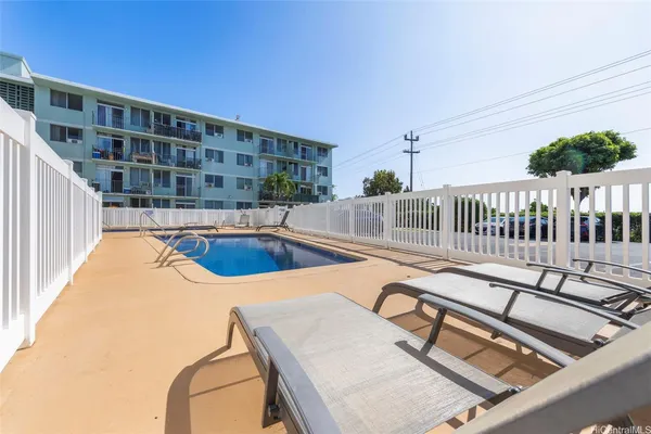 a view of a patio with table and chairs potted plants with sky view