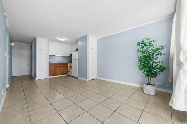 a view of kitchen with furniture and an empty room