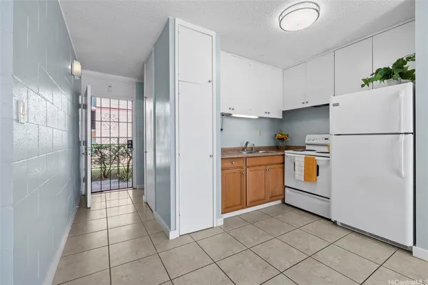 a kitchen with white cabinets and white appliances