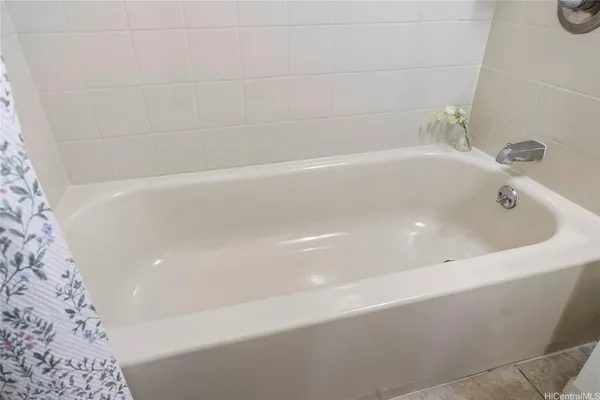 a view of an empty room and bathroom