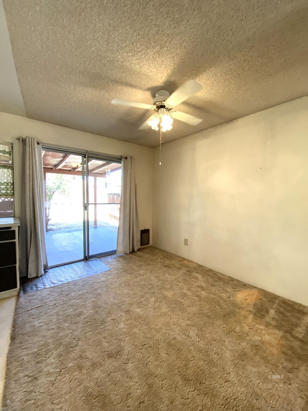 133 Purple Sage Lane Ridgecrest, CA 93555 - Photo 9 of 27 an empty room with windows and ceiling fan