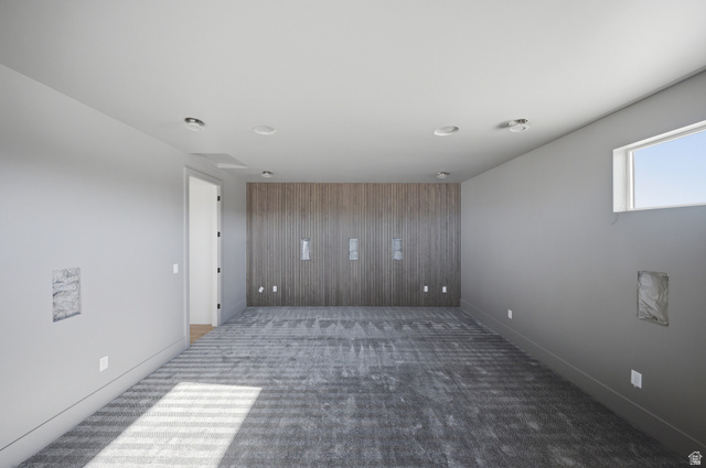 3011 East Rimrunner Drive, Unit 302 St. George, UT 84790 - Photo 32 of 45 Unfurnished room with wood walls, carpet flooring, and an accent wall