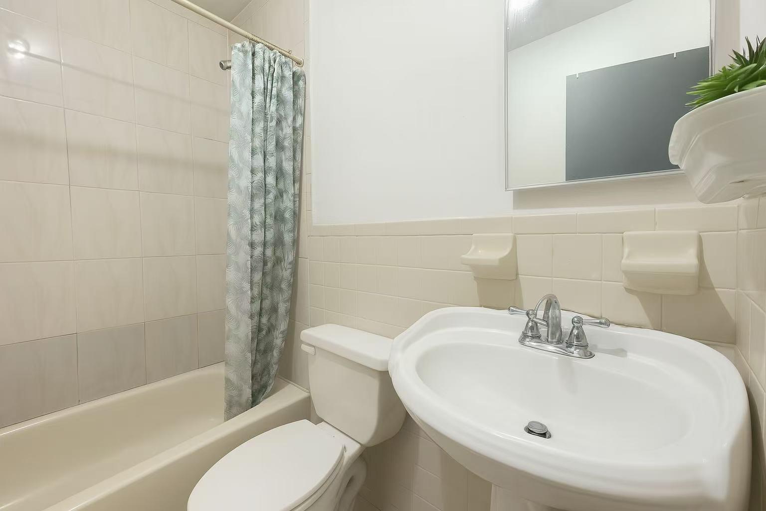 108-11 44th Avenue Queens, NY 11368 - Photo 5 of 11 a bathroom with a sink toilet and shower